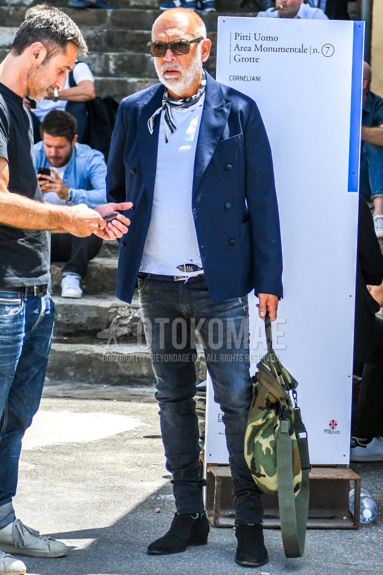 Tortoiseshell sunglasses, navy white and other bandana/neckerchief, plain navy tailored jacket, plain white t-shirt, brown and other leather belt, plain blue denim/jeans, navy side gore boots, olive green camo briefcase/handbag Matching spring/summer/fall men's coordinate outfits.
