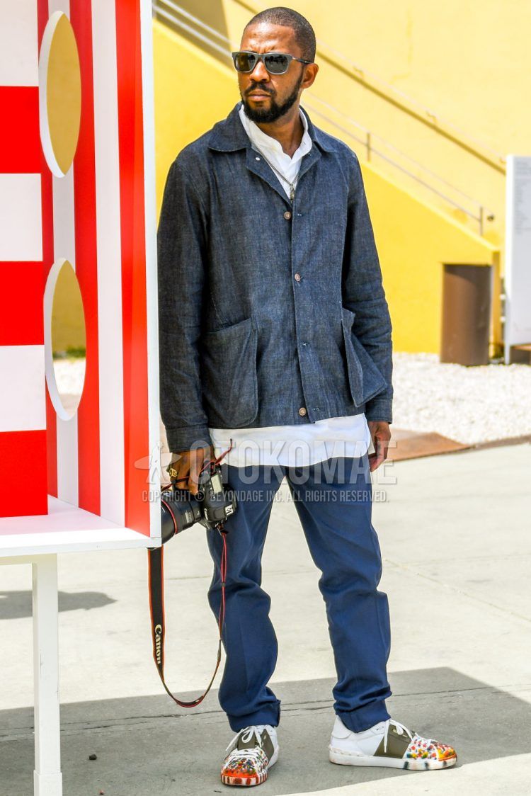 Summer spring and fall men's coordinate outfit with plain sunglasses, plain gray shirt jacket, plain white shirt, plain navy cotton pants, and Valentino white low-cut sneakers.