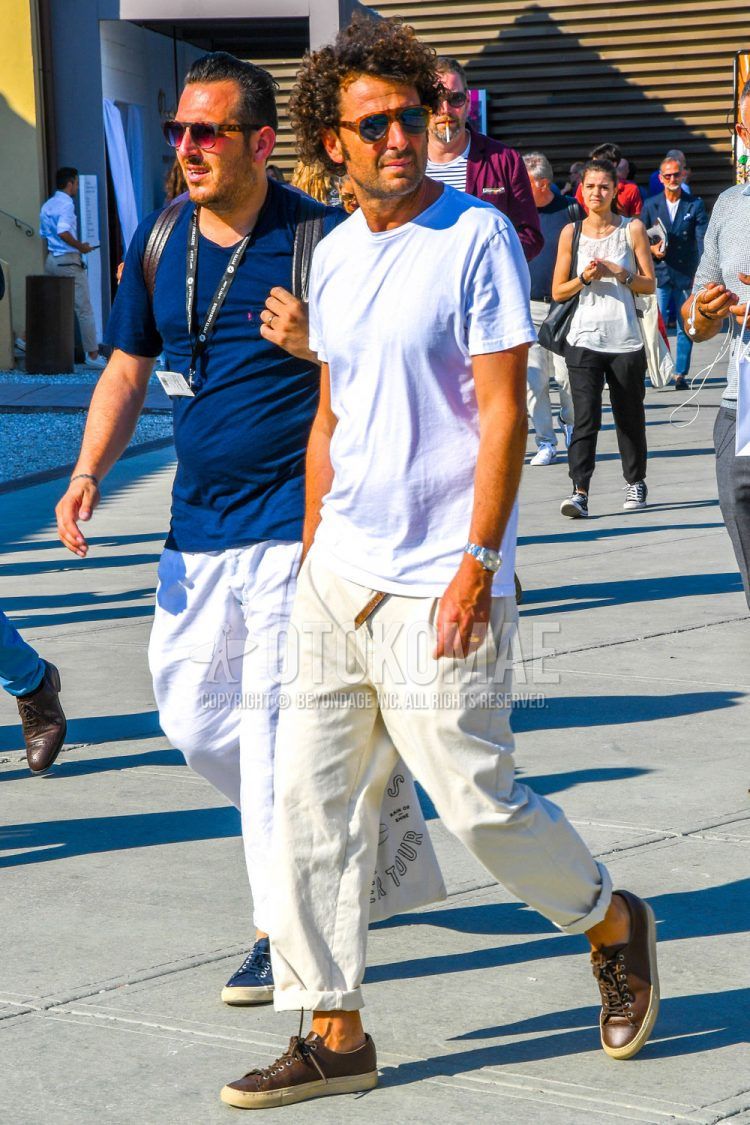 A summer men's coordinate outfit with plain sunglasses, a plain white T-shirt, plain white wide pants, and brown low-cut sneakers.