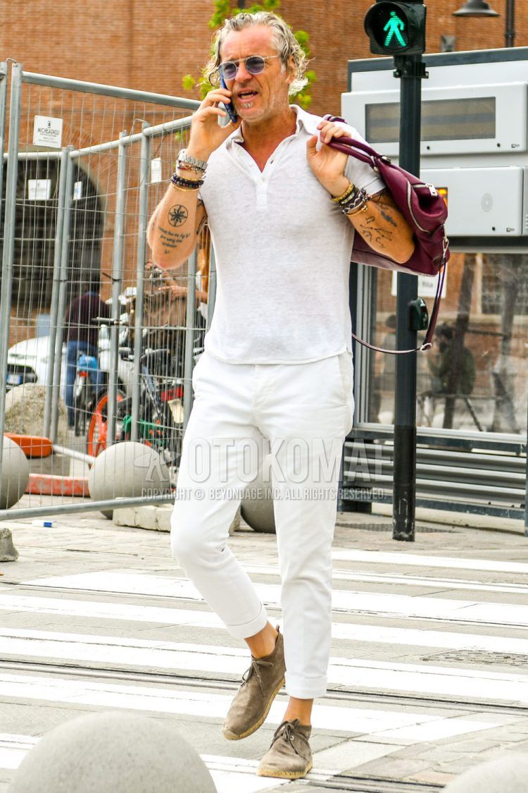 A summer men's coordinate outfit with plain sunglasses, a plain white polo shirt, plain white cotton pants, and gray suede leather shoes.