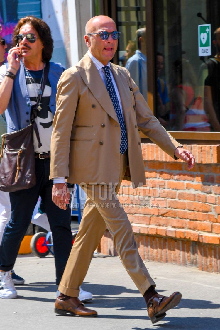 Men's spring, summer, and fall outfit with plain sunglasses, white striped shirt, plain brown socks, brown monk shoes leather shoes, plain brown suit, and brown other tie.