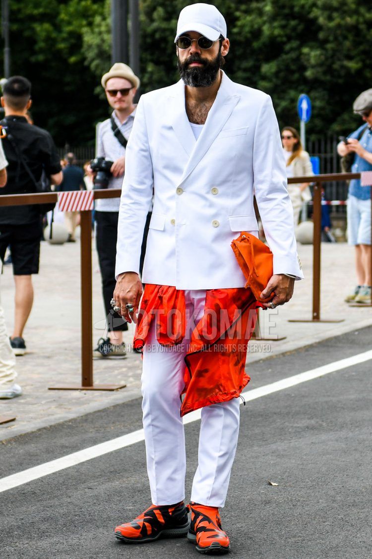 A men's fall/summer/spring coordinate outfit with a solid color baseball cap, solid color sunglasses, solid color white tailored jacket, solid color white t-shirt, solid color white slacks, and orange high-cut sneakers.