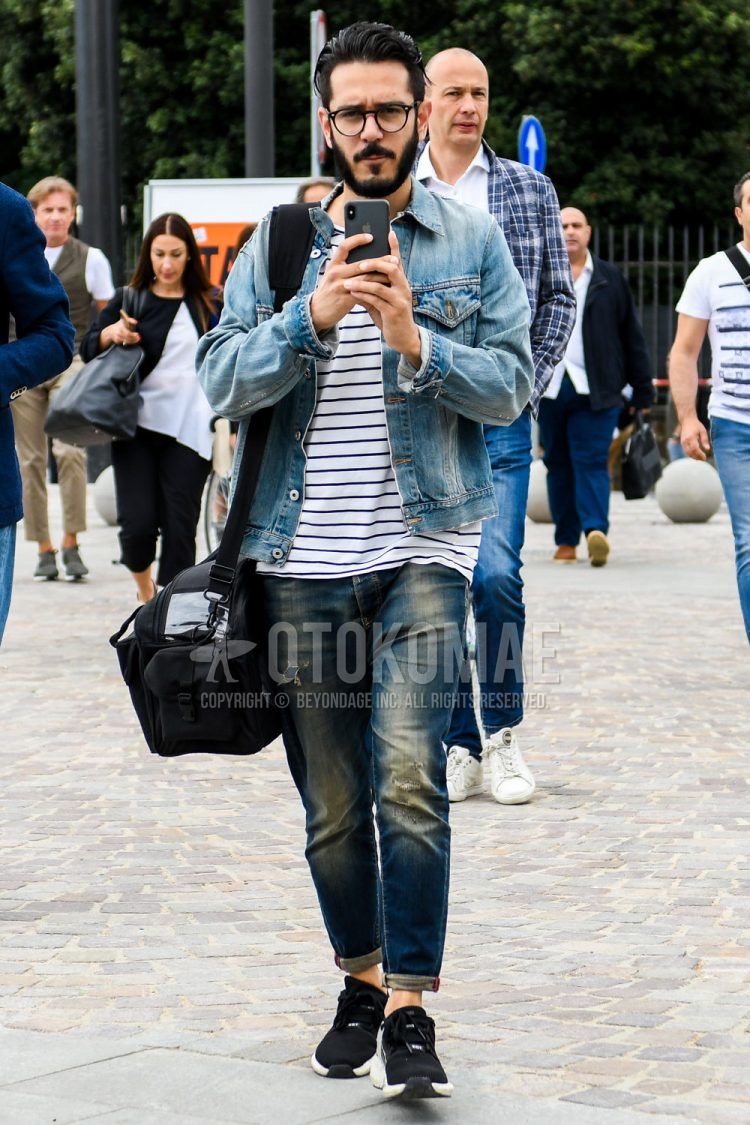 Spring/summer/fall men's coordinate outfit with plain blue denim jacket, white striped t-shirt, plain blue denim/jeans, black low-cut sneakers, and plain black shoulder bag.