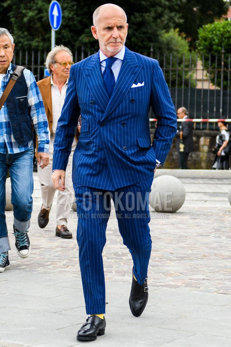 Spring, summer, and fall men's coordinate outfit with plain light blue shirt, plain yellow socks, black monk shoe leather shoes, blue striped suit, and plain blue tie.