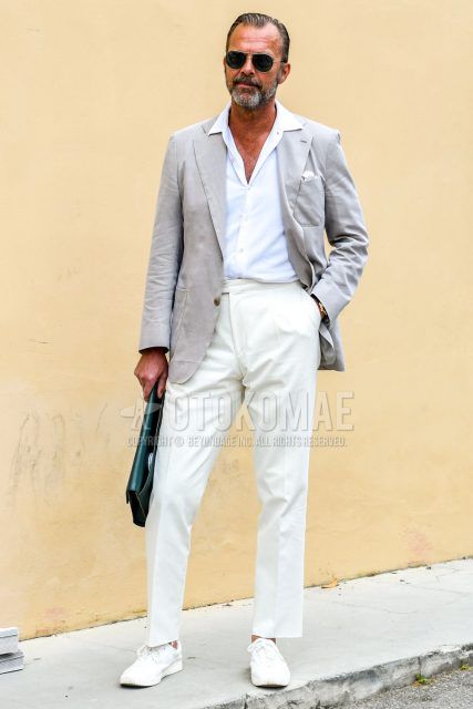 A summer/spring/fall men's outfit with plain sunglasses, plain gray tailored jacket, plain white shirt, plain white beltless pants, plain white ankle pants, white low-cut sneakers, and plain black clutch bag/second bag/drawstring.