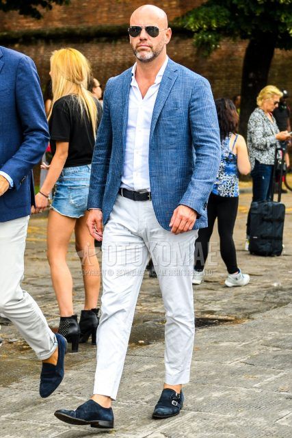 Spring, summer and fall men's coordinate outfit with plain silver sunglasses, blue checked tailored jacket, plain white shirt, plain black leather belt, plain white chinos, navy monk shoes leather shoes, navy suede shoes leather shoes.