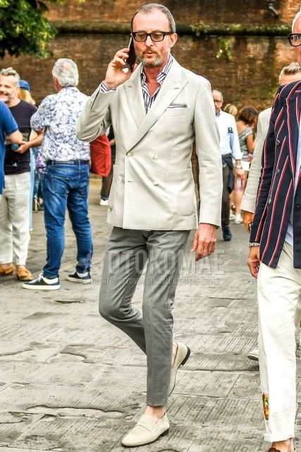 Spring, summer, and fall men's coordinate outfit with plain brown sunglasses, plain gray tailored jacket, white striped shirt, plain gray slacks, white and gray coin loafers leather shoes, and white and gray suede shoes leather shoes.