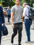 Summer men's coordinate outfit with plain gray sweater, plain white t-shirt, plain black cargo pants, plain black jogger pants/ribbed pants, plain black socks, and black low-cut sneakers by Vans.