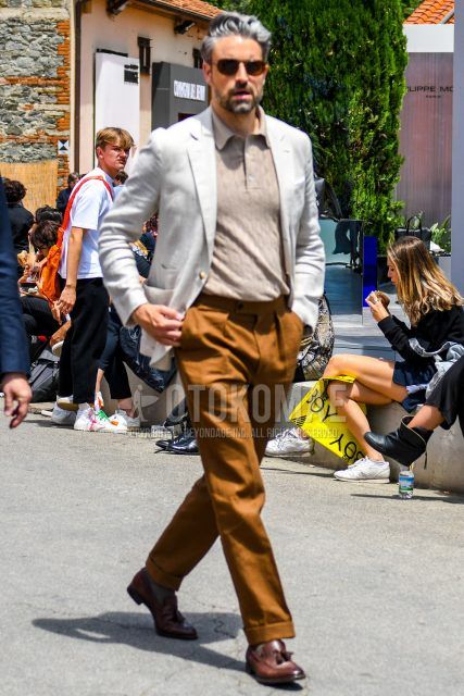 Summer spring and fall men's coordinate outfit with plain sunglasses, plain white tailored jacket, plain beige polo shirt, plain brown beltless pants, plain pleated pants, and brown tassel loafer leather shoes.