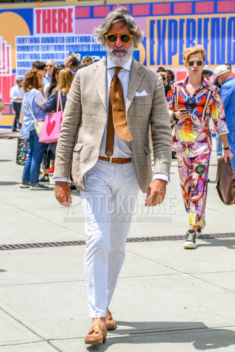 A spring/summer/fall men's outfit with plain sunglasses, beige checked tailored jacket, plain white shirt, plain brown leather belt, plain white ankle pants, plain white cotton pants, brown tassel loafer leather shoes, and plain brown tie.