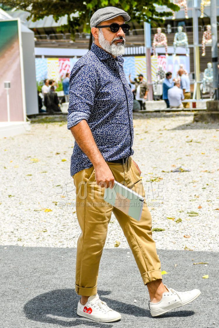 Spring, summer and fall men's coordinate outfit with plain gray other, plain sunglasses, navy other shirt, plain black leather belt, plain beige cotton pants, plain beige chinos and white low-cut sneakers from Comme des Garcons.