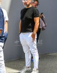A summer men's coordinate outfit with plain sunglasses, a plain black sweater, a plain white t-shirt, a plain white leather belt, plain white cotton pants, and white low-cut sneakers.