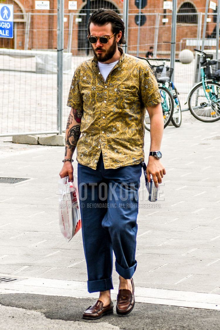 Summer men's coordinate outfit with plain sunglasses, yellow and other shirts, plain white t-shirt, plain blue wide-leg pants, and brown coin loafer leather shoes.
