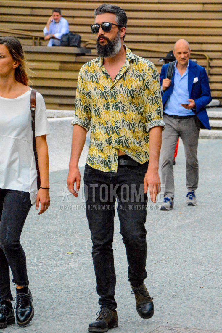 A spring/summer men's coordinate outfit with plain sunglasses, yellow/white and other shirts, plain black leather belt, plain black/navy denim/jeans, and black plain toe leather shoes.