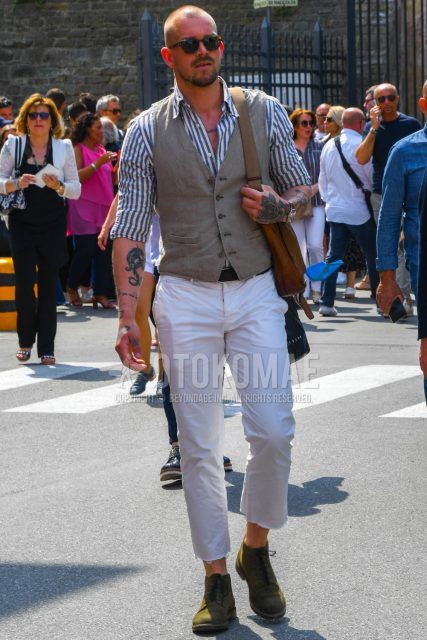 A spring/summer men's coordinate outfit with plain sunglasses, plain gray gilet, white striped shirt, plain leather belt, plain white cotton pants, and olive green work boots.