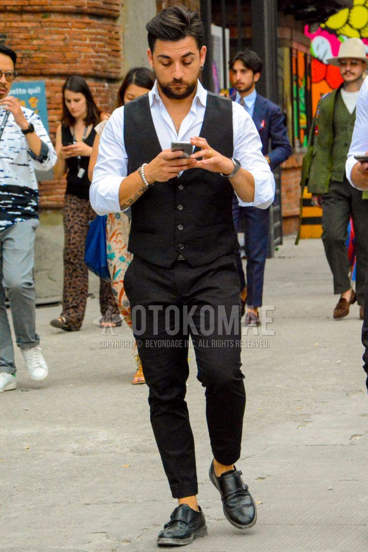 Spring, summer and fall men's coordinate outfit with plain white shirt, plain black gilet, plain black cotton pants and black monk shoes leather shoes.