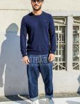 Spring and fall men's coordinate outfit with solid color sunglasses, solid color navy sweater, solid color blue denim/jeans, and white low-cut sneakers.