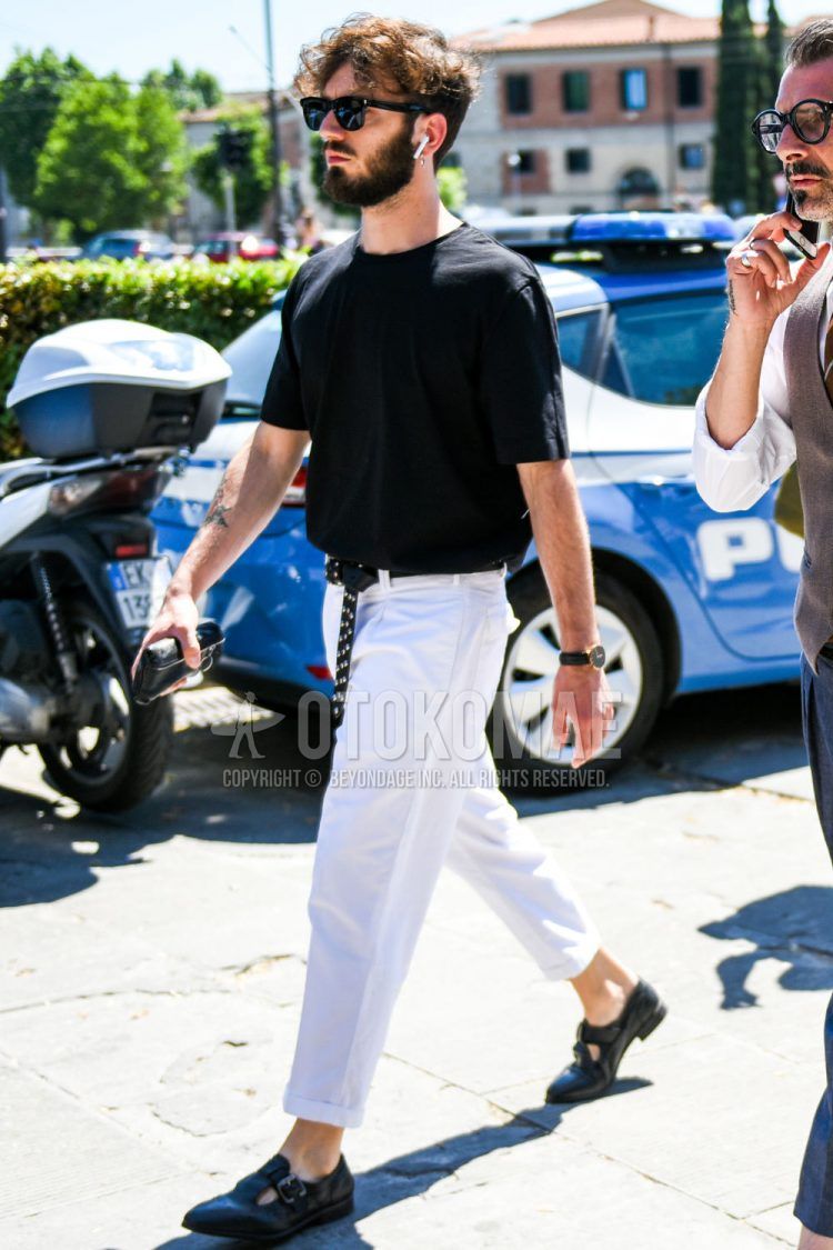A summer men's coordinate outfit with plain black Wellington sunglasses, a plain black T-shirt, a plain black mesh belt, plain white cotton pants, and black leather sandals.