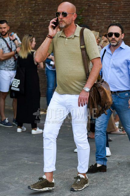 Summer men's coordinate outfit with plain silver/black sunglasses, plain beige polo shirt, plain white damaged jeans, olive green low-cut sneakers, and plain brown shoulder bag.