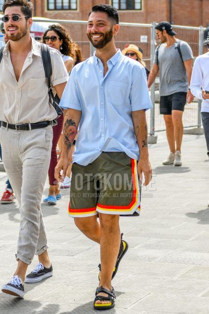 Summer men's coordinate outfit with plain light blue shirt, plain olive green shorts, and yellow/black sports sandals.