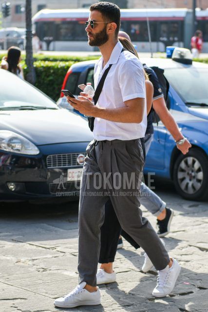 A summer men's coordinate outfit with plain gold sunglasses, plain white shirt, plain gray easy pants, and white low-cut sneakers.
