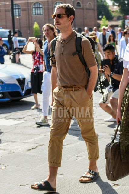 Summer men's coordinate outfit with brown tortoiseshell sunglasses, plain brown polo shirt, plain brown leather belt, plain beige cotton pants, and black leather sandals.