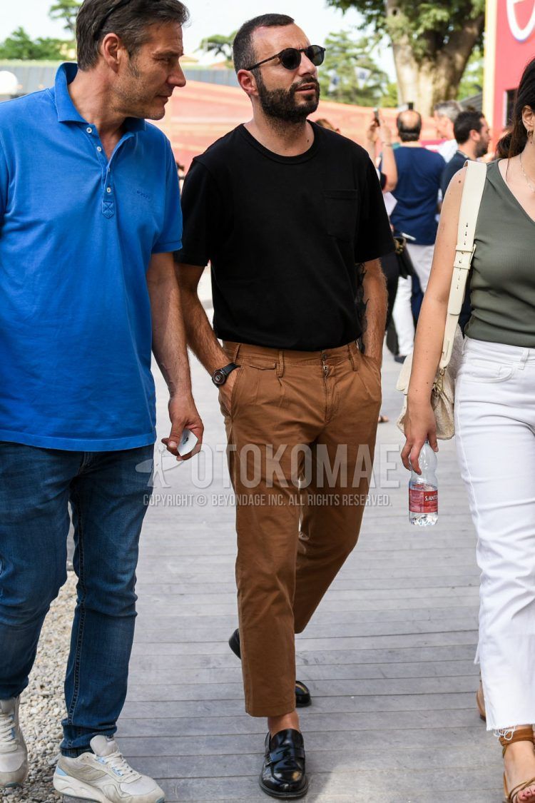 A summer men's coordinate outfit with plain sunglasses, plain black t-shirt, plain brown beltless pants, plain chinos, and black coin loafer leather shoes.