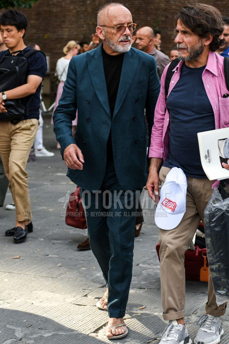 Spring and fall men's coordinate outfit with plain orange glasses, plain black T-shirt, gray flip flops, and plain blue suit.