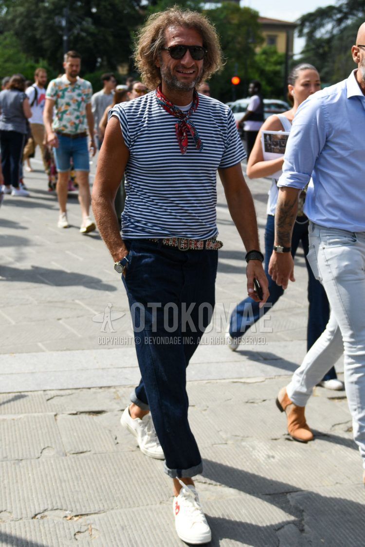 Teardrop brown tortoiseshell sunglasses, red other bandana/neckerchief, white and navy striped t-shirt, red other leather belt, plain navy denim/jeans, Play Comme des Garcons Converse Jack Purcell white low cut sneakers Summer men's coordinate outfit.