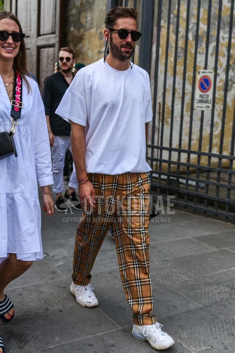 A summer men's coordinate outfit with plain black Ray-Ban sunglasses, plain white t-shirt, Burberry check beige check slacks, and Asics Gel Cayano 5 OG white low-cut sneakers.