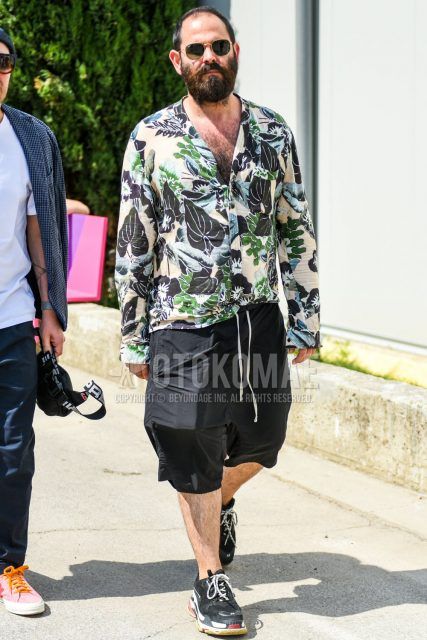 A summer-spring-fall men's coordinate outfit with a multi-colored botanical shirt, plain black shorts, and Balenciaga black low-cut sneakers.