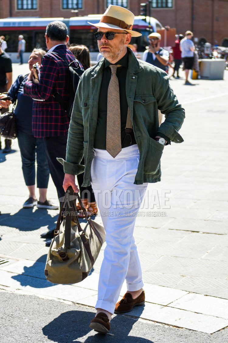 Spring and fall men's outfit with solid beige hat, solid black sunglasses, solid green safari jacket, solid green shirt, solid white beltless pants, suede brown tassel loafer leather shoes, solid beige Boston bag, solid brown tie.