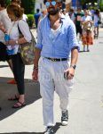 Spring, summer and fall men's coordinate outfit with plain blue sunglasses, plain light blue shirt, plain white t-shirt, plain black Gucci leather belt and black high-cut Converse sneakers.
