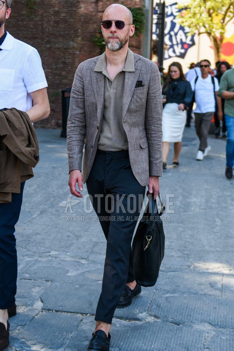 Solid brown/silver sunglasses, solid beige tailored jacket, solid beige polo shirt, solid gray slacks, solid ankle pants, solid beltless pants, black coin loafer leather shoes, and solid black briefcase/handbag for men in spring/summer Outfit.