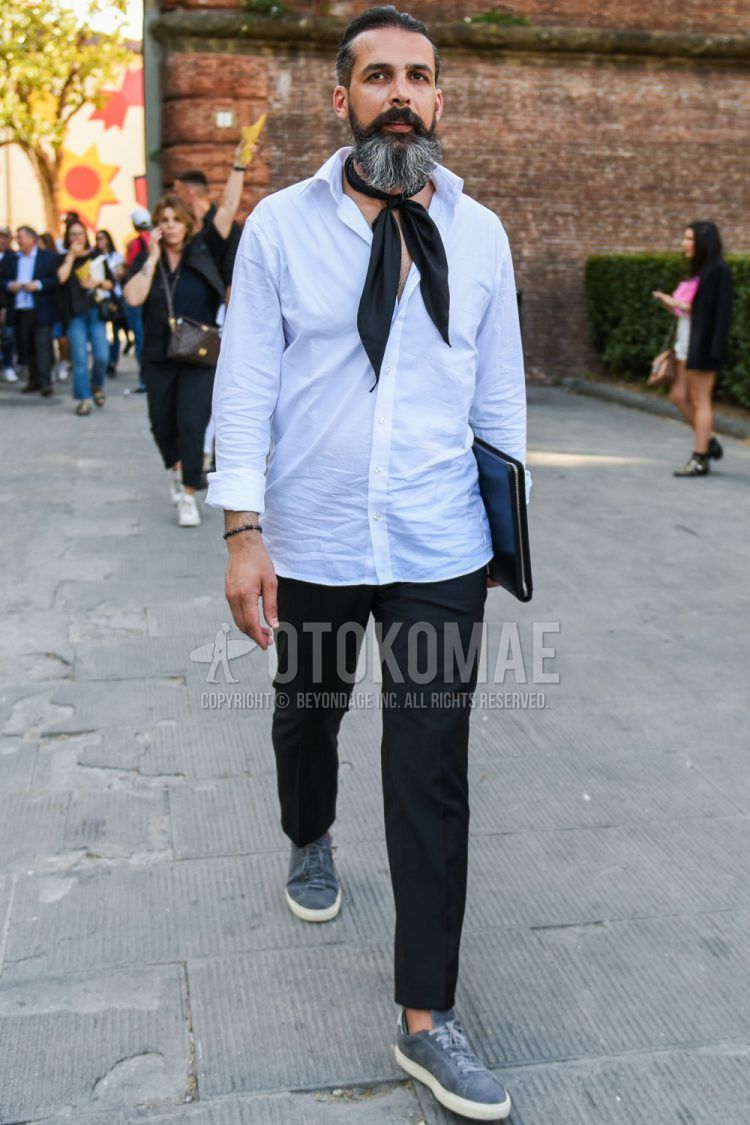 A men's spring/summer outfit with a plain black bandana/neckerchief, a plain white shirt, plain black slacks, and gray low-cut sneakers.