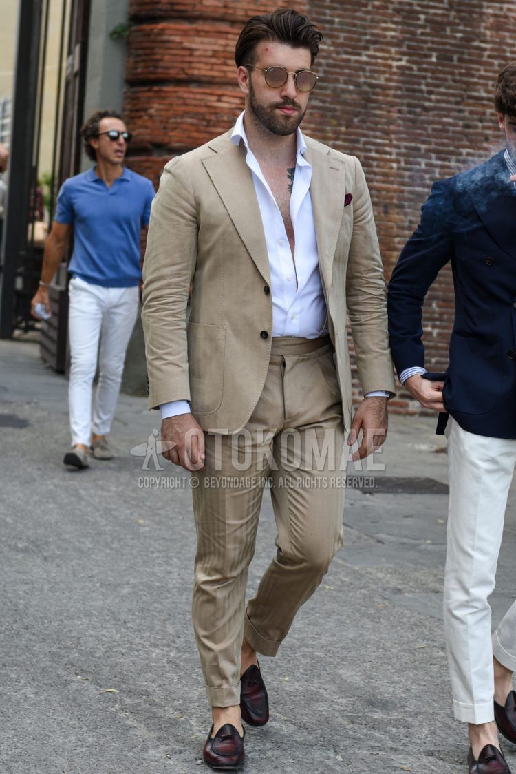 Spring, summer and fall men's coordinate outfit with plain brown sunglasses, plain white shirt, brown other loafer leather shoes and plain beige suit.