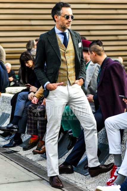 Men's fall/spring outfit with plain sunglasses, plain gray tailored jacket, yellow checked gilet, plain light blue shirt, plain white winter pants (corduroy, velour), plain black socks, brown tassel loafer leather shoes, navy other tie.