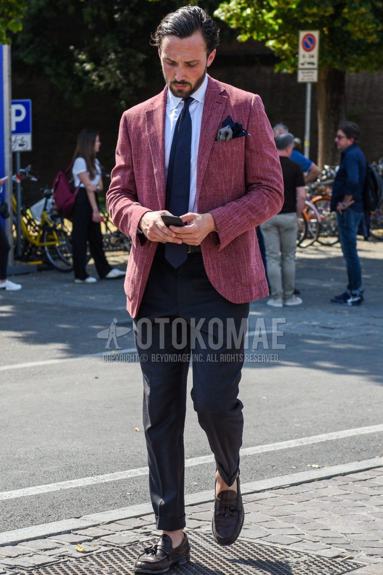 Spring, fall, and summer men's coordinate outfit with plain red tailored jacket, plain white shirt, plain black slacks, brown tassel loafer leather shoes, and plain navy tie.
