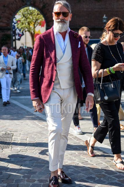 Spring and fall men's coordinate outfit with plain brown sunglasses, plain red tailored jacket, plain white shirt, plain white gilet, plain white cotton pants, and brown tassel loafer leather shoes.
