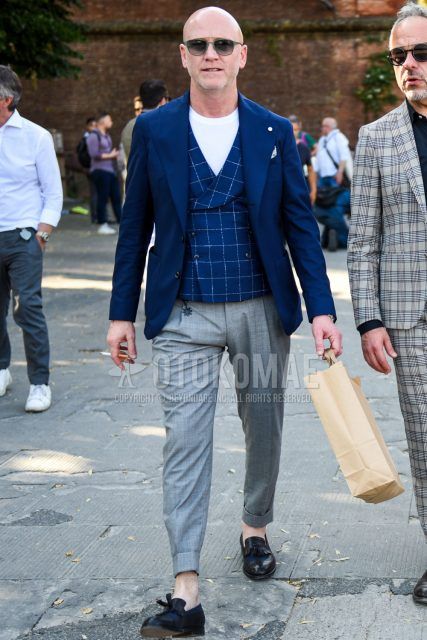 Spring, summer and fall men's coordinate outfit with plain green sunglasses, plain navy tailored jacket, navy check gilet, plain white t-shirt, plain gray slacks, plain pleated pants and black tassel loafer leather shoes.