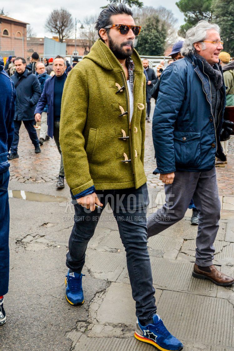 A men's fall/winter outfit with solid color sunglasses, olive green solid color others, gray solid color denim/jeans, and blue low-cut sneakers from Atlantic Stars.