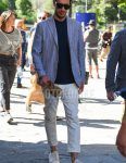 Spring and summer men's coordinate outfit with brown tortoiseshell sunglasses, gray striped tailored jacket, plain navy t-shirt, plain white cotton pants, plain cropped pants, and white low-cut sneakers.