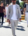 A spring/summer men's coordinate outfit with plain black sunglasses, plain white t-shirt, white low-cut sneakers, and gray striped suit.