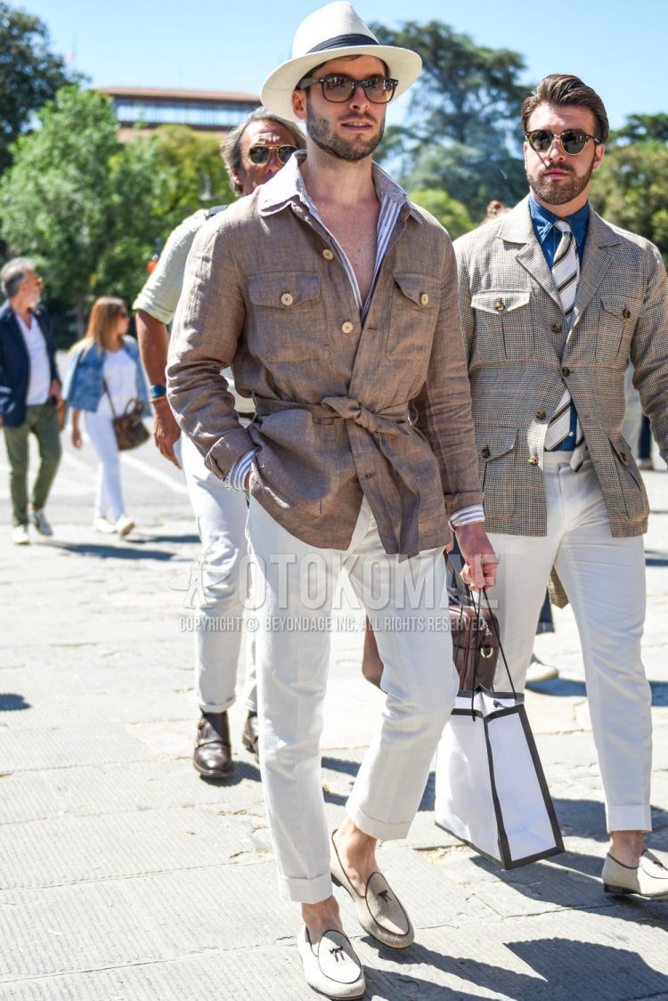 Spring and summer men's coordinate outfit with solid beige hat, solid black Wellington Ray-Ban sunglasses, solid beige safari jacket, gray striped shirt, solid white slacks, and white tassel loafer leather shoes.