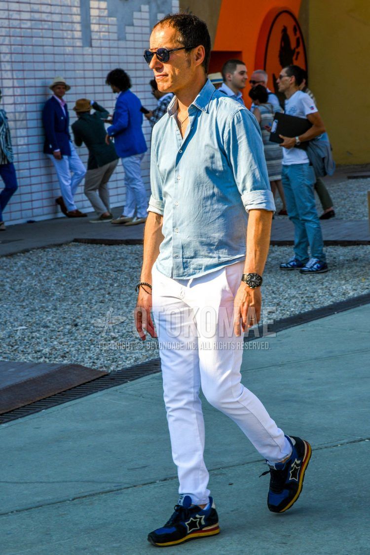 Spring, summer and fall men's coordinate outfit with plain sunglasses, plain light blue shirt, plain white chinos and Atlantic Stars blue low-cut sneakers.