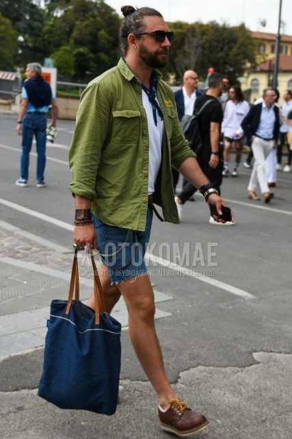 Plain black sunglasses, navy other bandana/neckerchief, plain olive green shirt, plain white t-shirt, plain blue denim/jeans, plain shorts, plain brown U-tip leather shoes, and plain navy briefcase/handbag for a summer men's outfit. Outfit.
