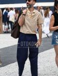 A summer men's outfit with brown tortoiseshell sunglasses, beige checked shirt, plain navy wide pants, plain chinos, plain pleated pants, white low-cut sneakers, and plain brown briefcase/handbag.