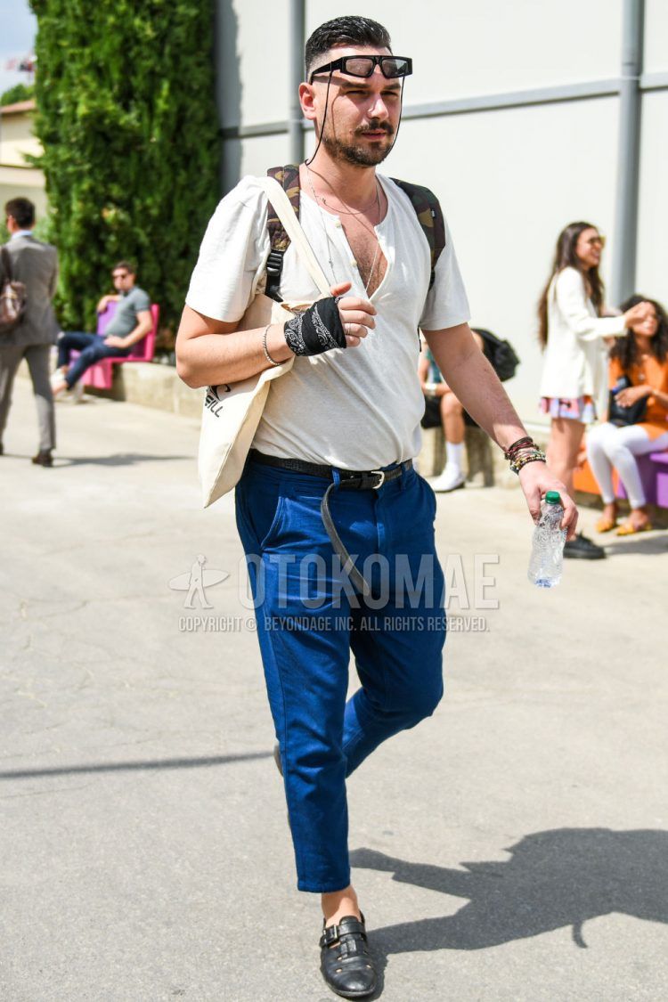 Summer men's coordinate outfit with plain black sunglasses, plain white t-shirt with henley neck, plain black leather belt, plain blue ankle pants, and black other leather shoes.