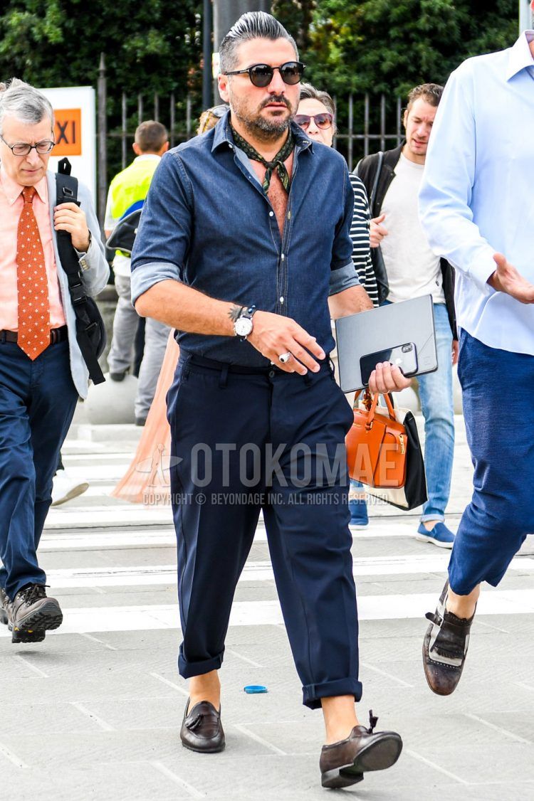 Spring/Summer/Fall men's coordinate outfit with plain black sunglasses, black other bandana/neckerchief, plain blue denim/chambray shirt, plain navy slacks, and brown tassel loafer leather shoes.
