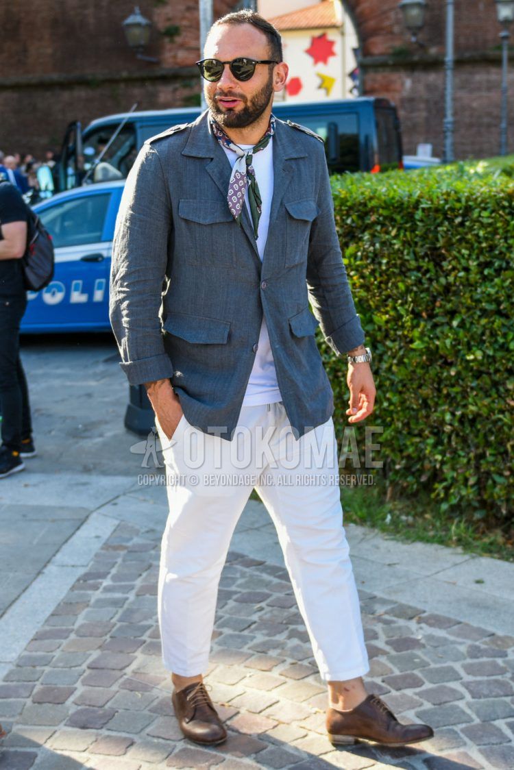Spring, summer and fall men's coordinate outfit with plain black sunglasses, multi-colored other scarf/stall, plain gray safari jacket, plain white t-shirt, plain white cotton pants and brown plain toe leather shoes.